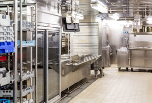 Commercial kitchen with stainless steel appliances and utensils.
